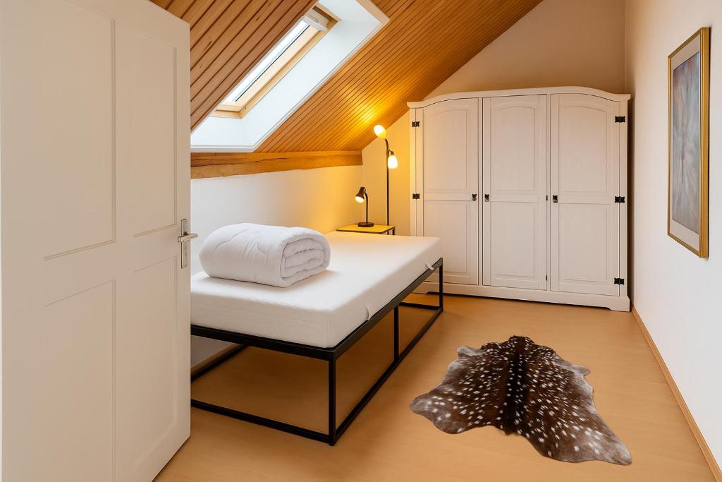 a bedroom with a bed and a skylight at Bockhorn Farmhouse in Bockhorn