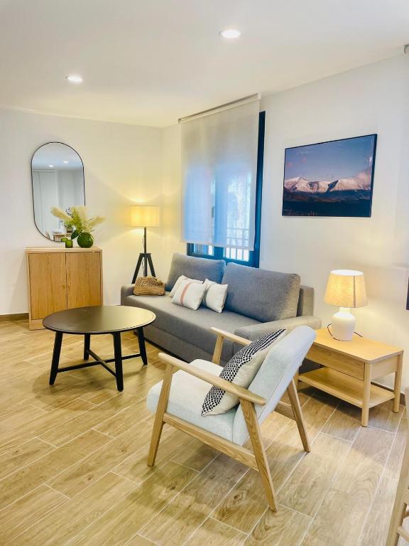 a living room with a couch and a table at Apartamentos San Nicolas Jaca in Jaca