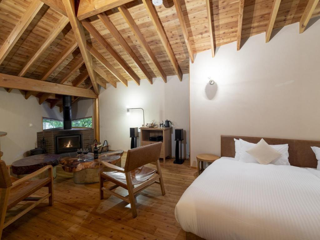 a bedroom with a bed and a desk and a fireplace at Hakone Retreat villa 1/f in Hakone