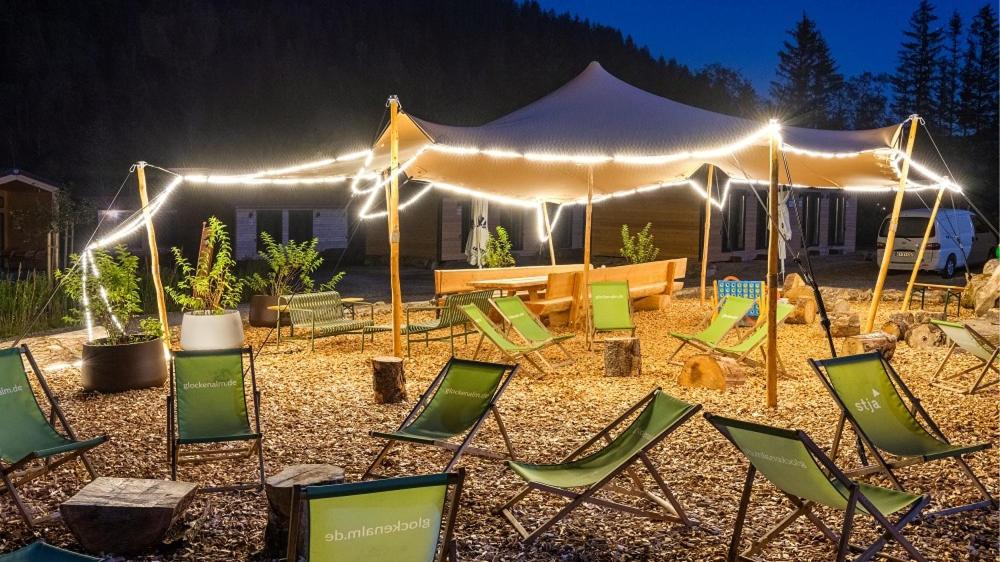 a group of lawn chairs in front of a tent at NATURAMA Glockenalm in Fischbachau
