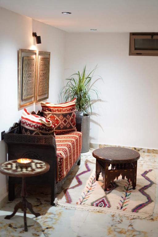 a living room with a couch and a table at Medina Loft Your Artistic Escape in Rabat