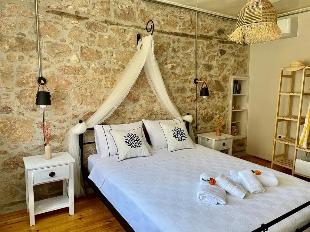 a bedroom with a white bed with pillows on it at Urbana - Ayvalık in Ayvalık