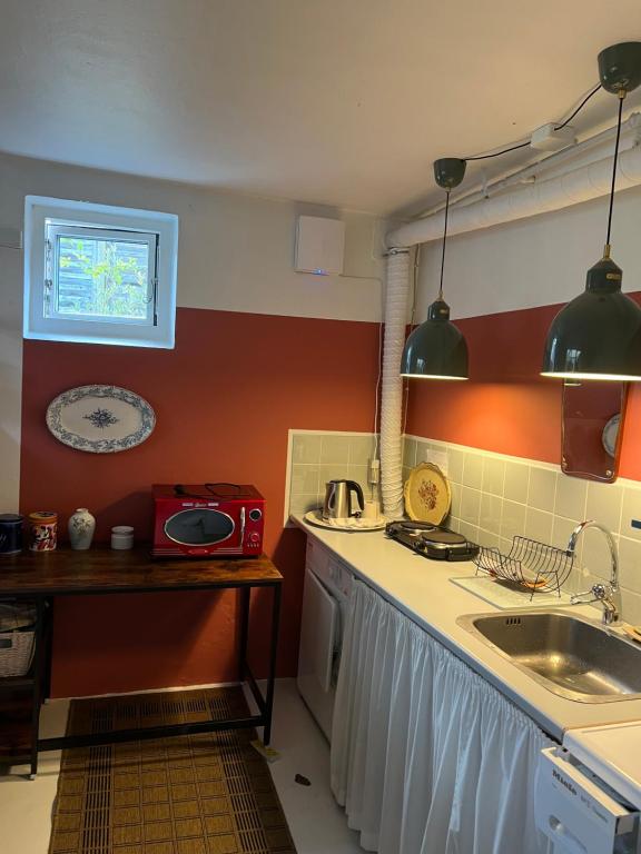 a kitchen with a sink and a counter top at Lises bed and breakfast in Svendborg