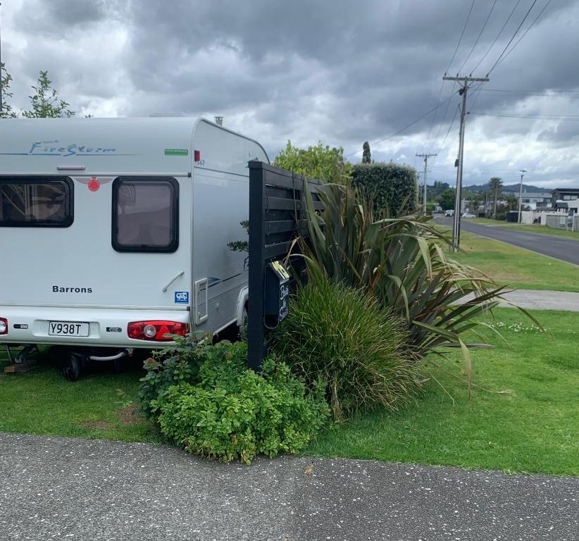 a white trailer parked on the side of a road at Beside the Seaside in Whangamata