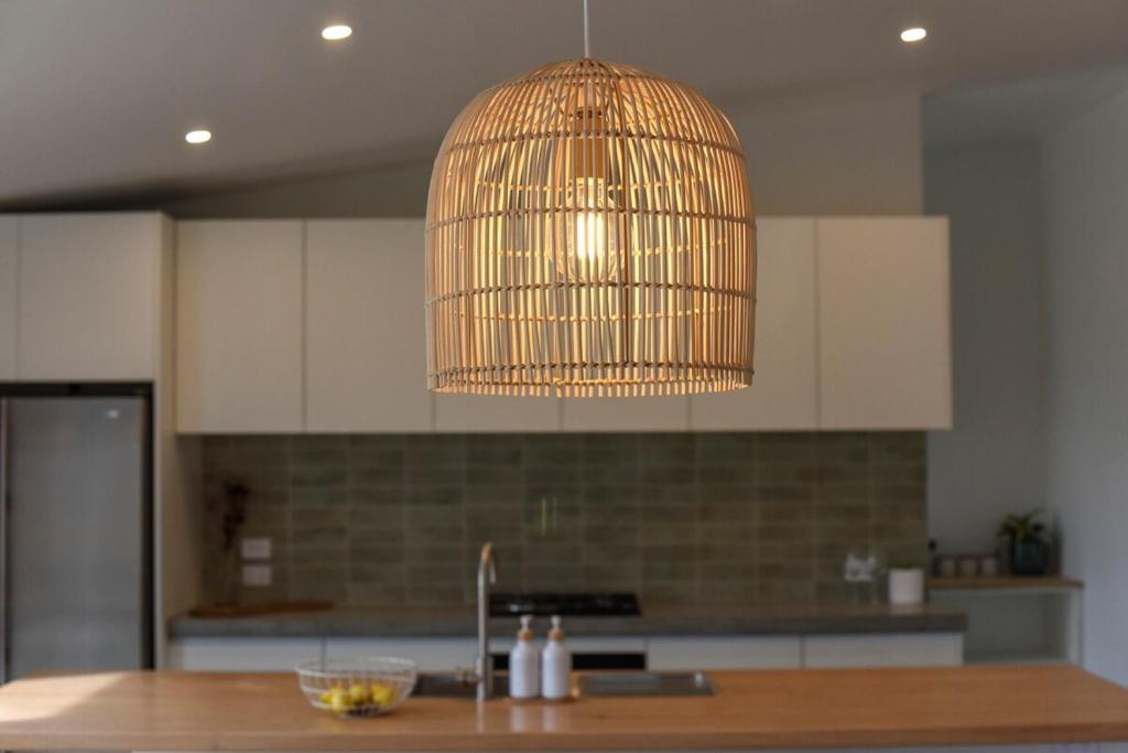 a kitchen with a bird cage hanging from a ceiling at A newly built 3 bedroom home in Methven