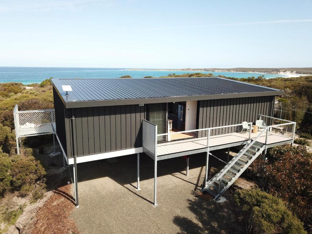 an aerial view of a house with a solar roof at Sommerhus Danish inspired beach front retreat in Vivonne Bay