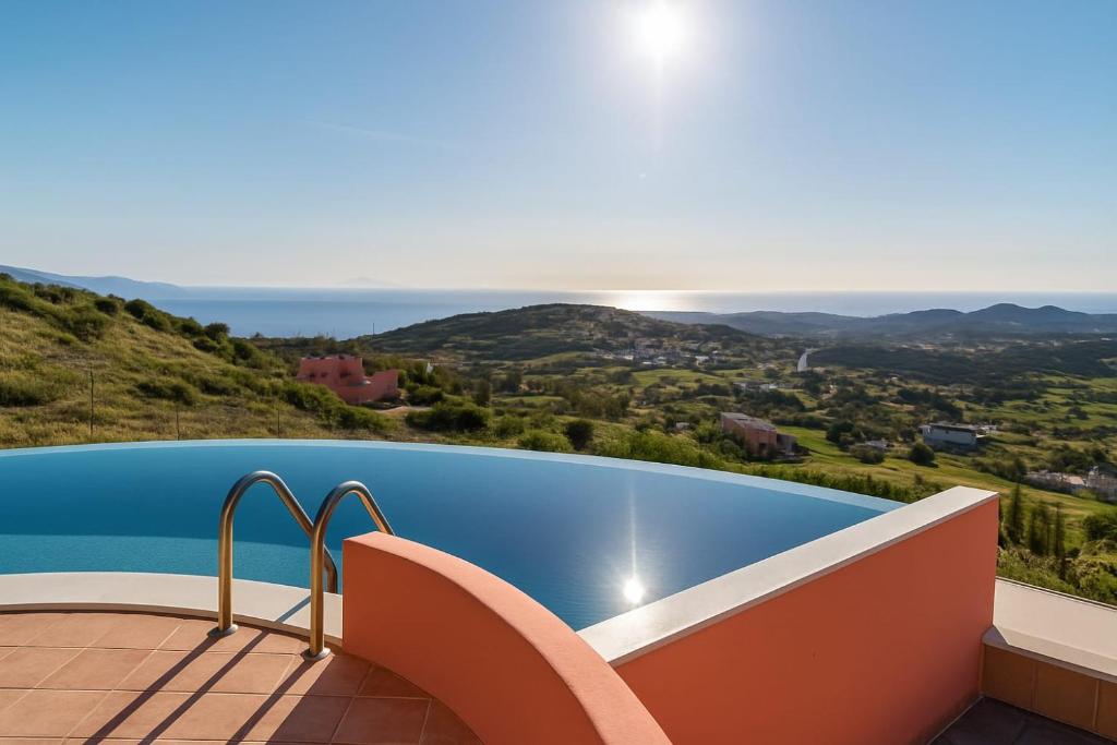 a swimming pool with a view of the ocean at Villa Malia, Eco-Chic, Tranquility, Sea Views & Luxury Cycladic Island Escape in Tálanda