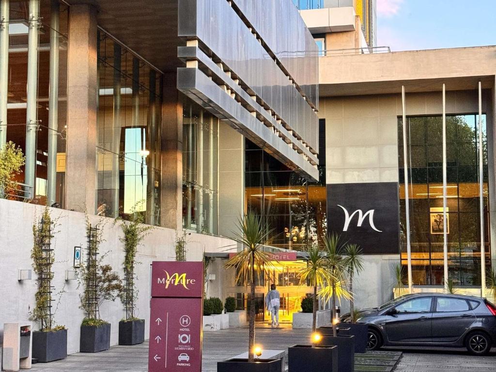 a car parked in front of a building at Mercure Concepcion in Concepción