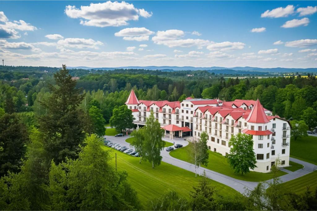 an aerial view of a large building with red roofs at Hotel Nowy Zdrój - Centrum Zdrowia i Wypoczynku in Polanica-Zdrój
