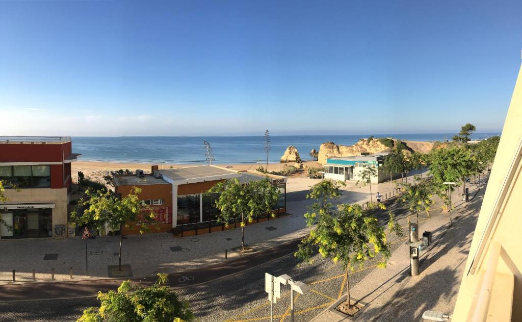 a view of a town with the ocean in the background at Portugal Algarve Beach Apartment in Portimão