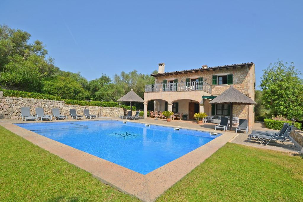 a large swimming pool in front of a house at Sinia in Petra