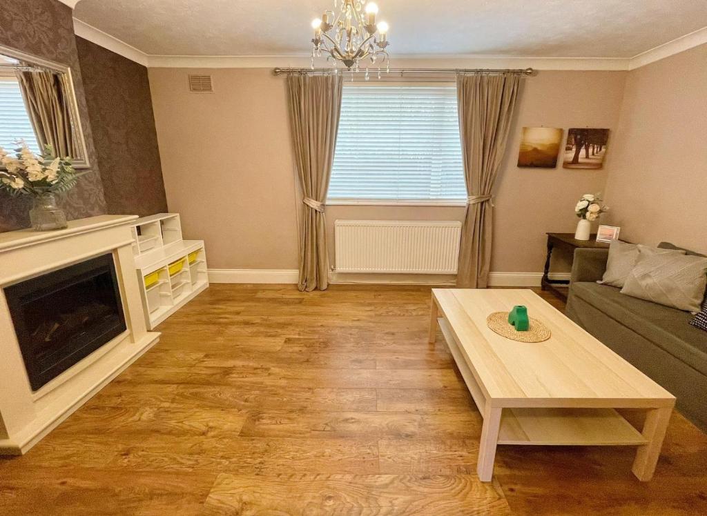 a living room with a couch and a fireplace at Detached 3-Bedroom House, Durham in Gilesgate