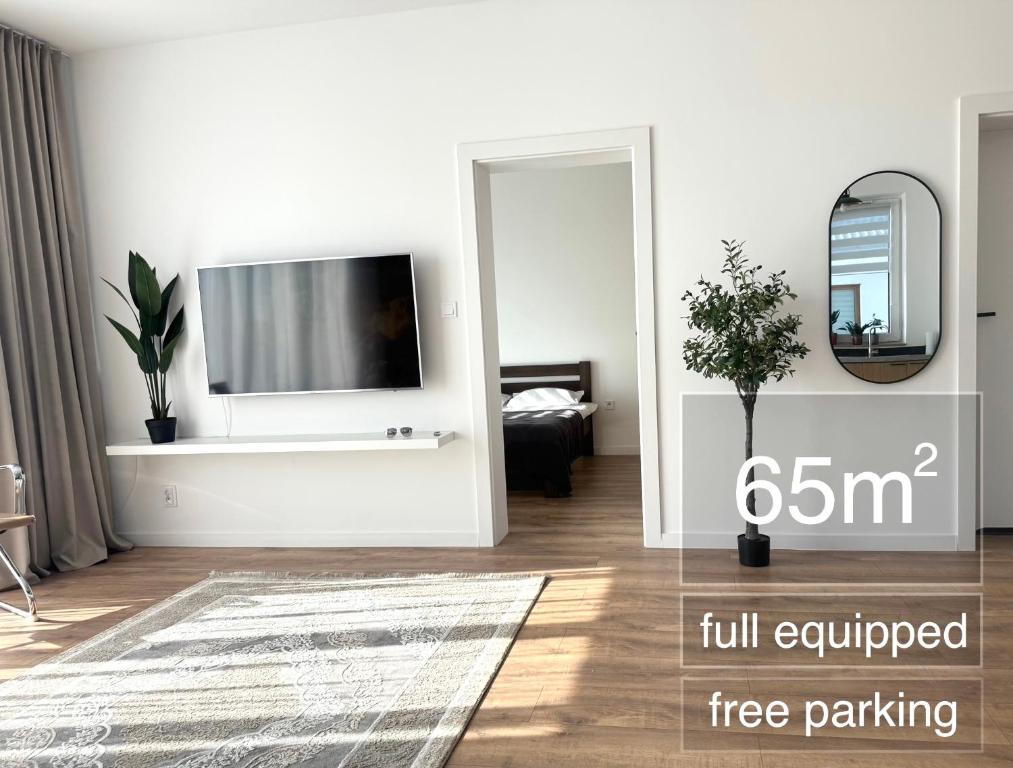 a living room with a flat screen tv on a wall at TIMELESS Apartment in Warsaw