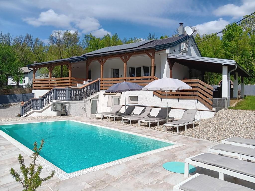 a house with a swimming pool in front of a house at Villa Manta Crikvenica in Crikvenica