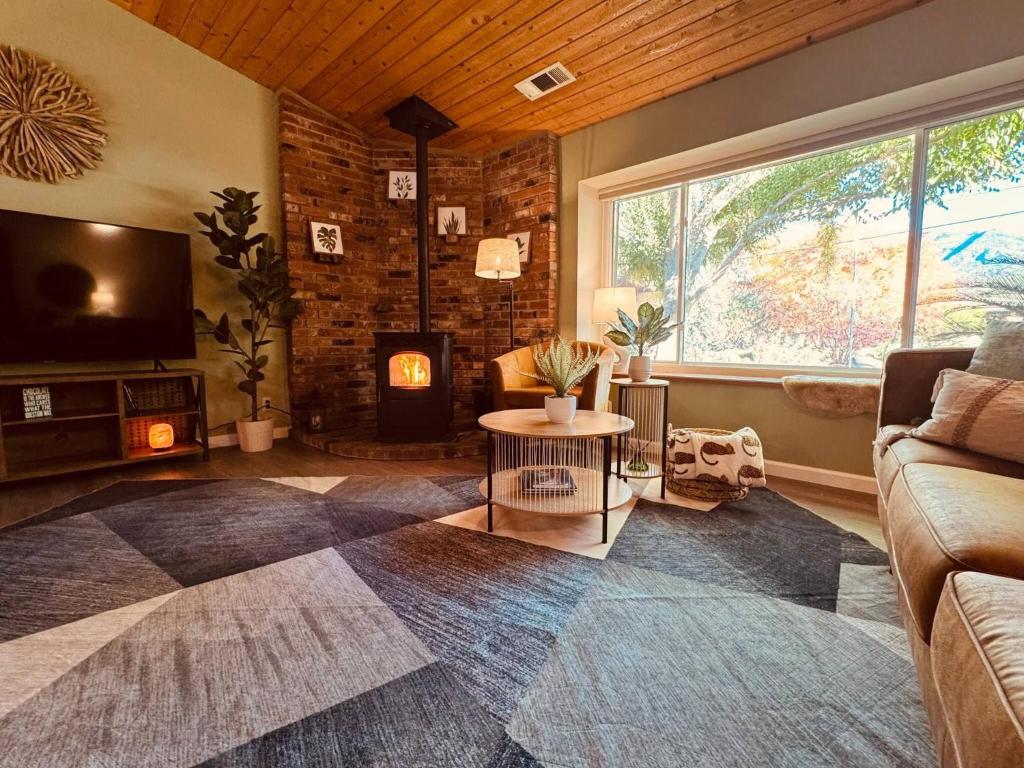 a living room with a couch and a fireplace at Magic Sequoia Spacious Home in Three Rivers
