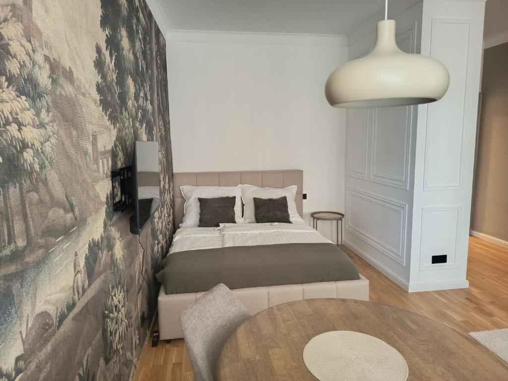 a bedroom with a bed and a large wall at Suite 16 City Apartment Korneuburg in Korneuburg