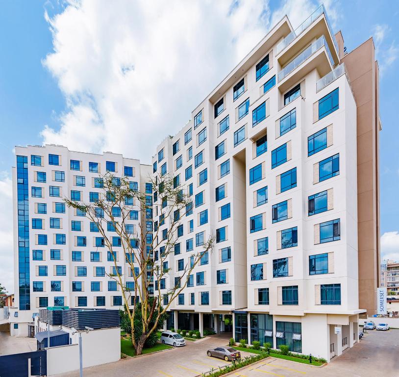 a large white building with blue windows at Somerset Westview Nairobi in Nairobi