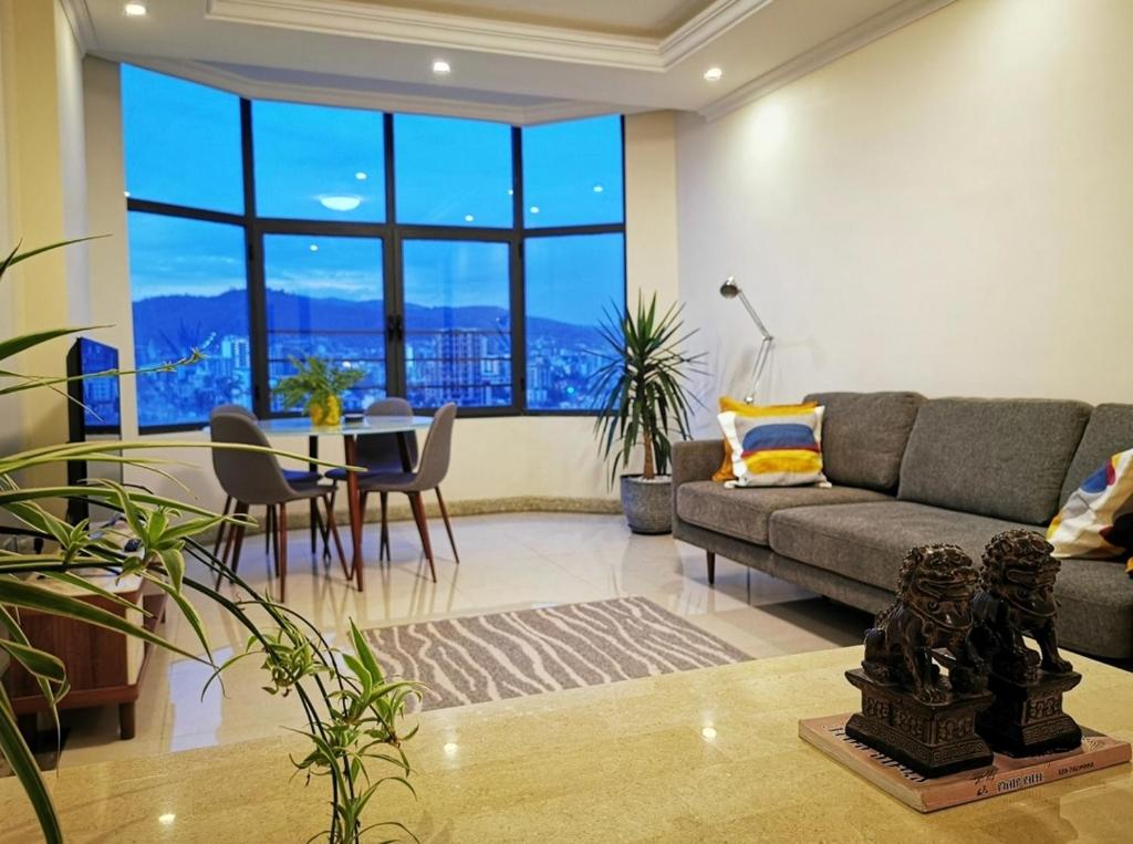 a living room with a couch and a table at Central Location, Breathtaking Views! in Addis Ababa