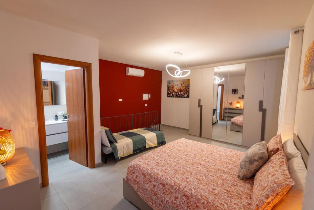 a bedroom with a bed and a bathroom with a mirror at Piazza Statuto - Appartamento con WiFi e ac in Asti