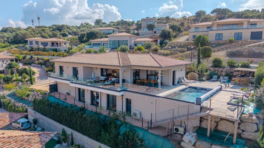 an aerial view of a house with a swimming pool at Villa Terra Bella hauteur de la ville avec piscine et vue mer in Propriano