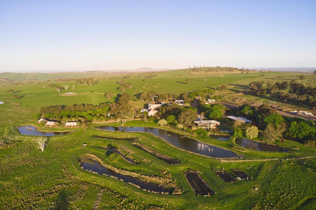 an aerial view of a golf course with a river at Tuki Retreat in Smeaton