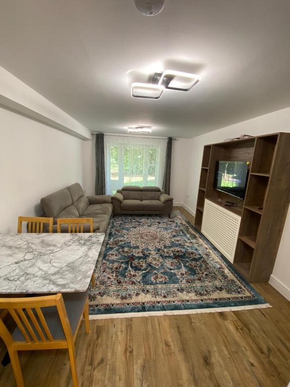 ein Wohnzimmer mit Sofa und Tisch in der Unterkunft Luxury 2 bed flat in Guildford in Stoughton
