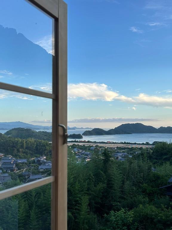 a window view of a city and the water at Yugashira Kuu ゆがしら空 in Imabari