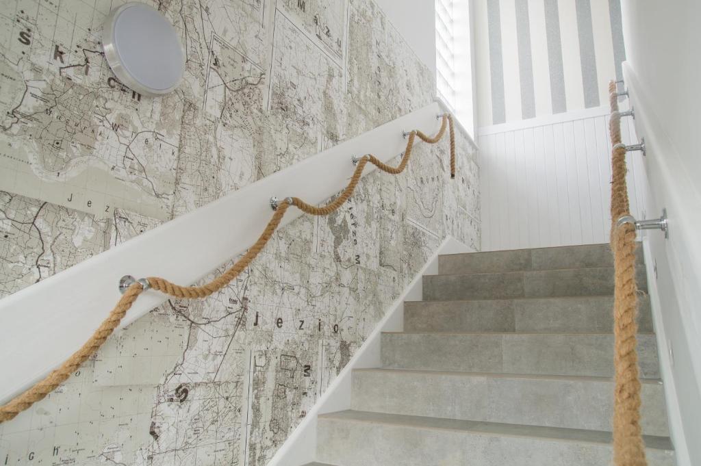 a staircase with a wall with a map on it at Pokoje na Szlaku Kajki 20A in Mikołajki