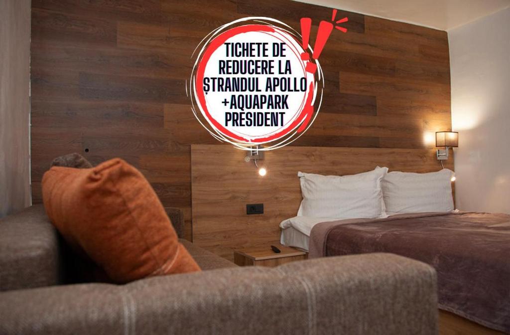 a hotel room with a bed and a couch at CASA TARANEASCA in Baile Felix