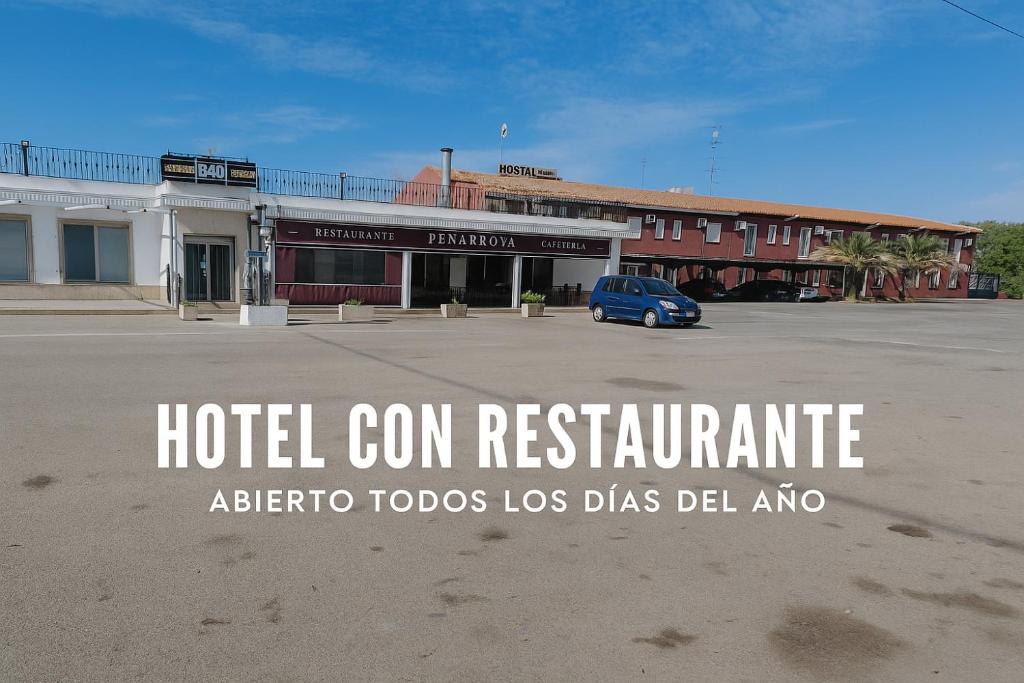 a hotel corn restaurant sign in front of a parking lot at Hotel Peñarroya in Argamasilla de Alba