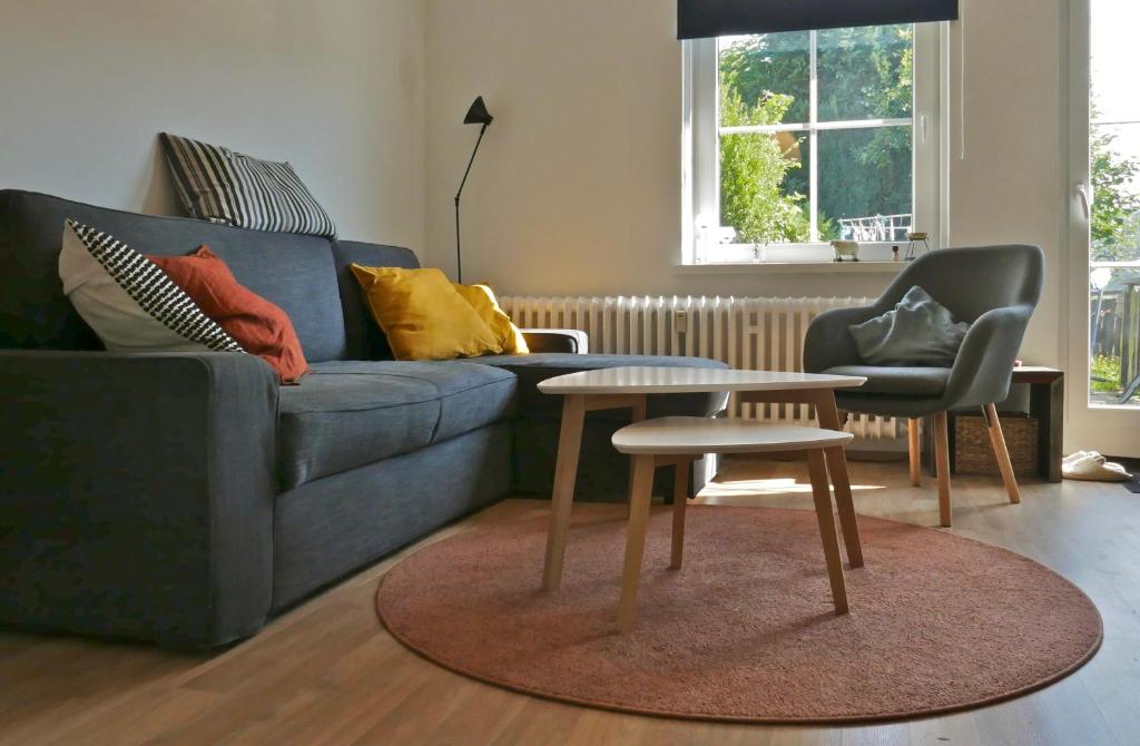 a living room with a couch and a table and chairs at ÜbermTal in Schmallenberg