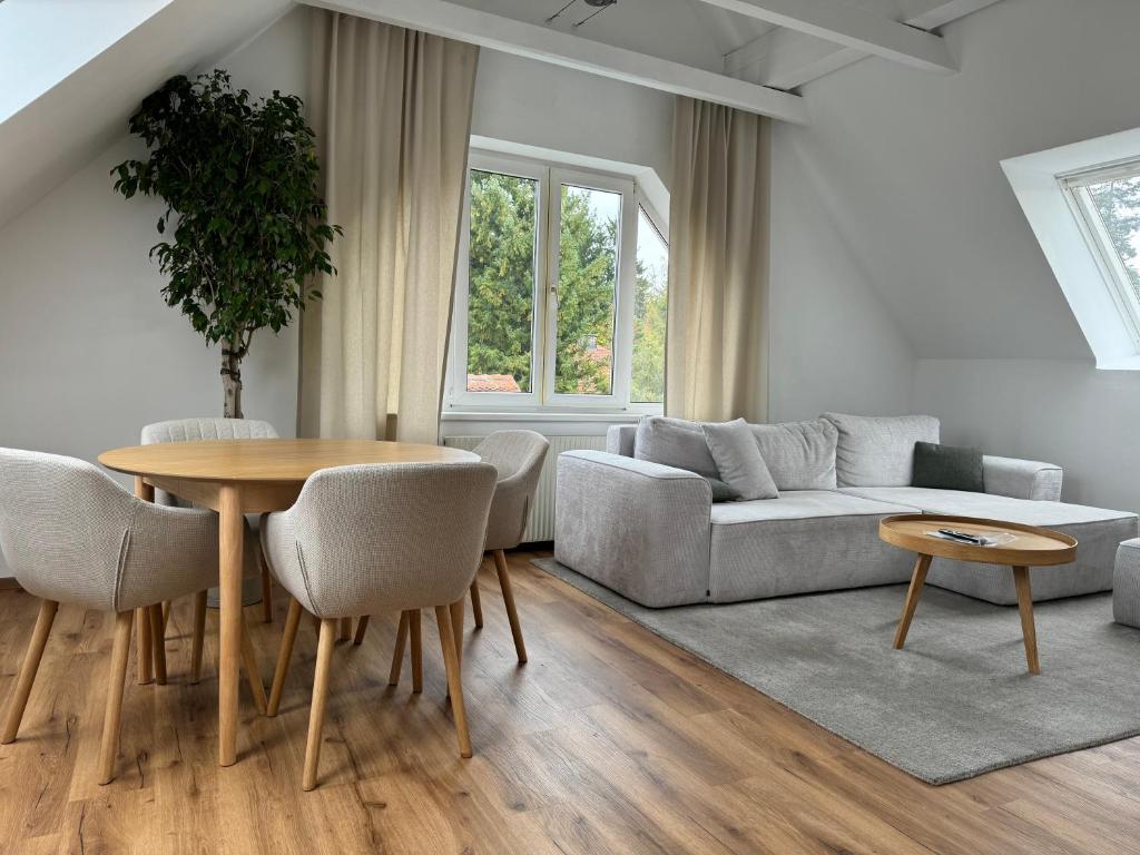 a living room with a table and a couch at Appartement Khodai in Graz