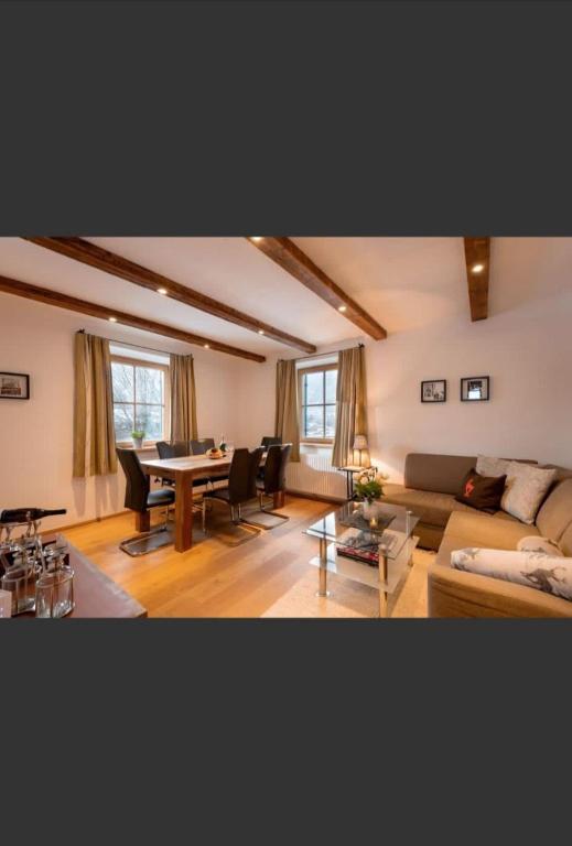 a living room with a couch and a table at Haus Huber Sonnenhofweg in Kitzbühel