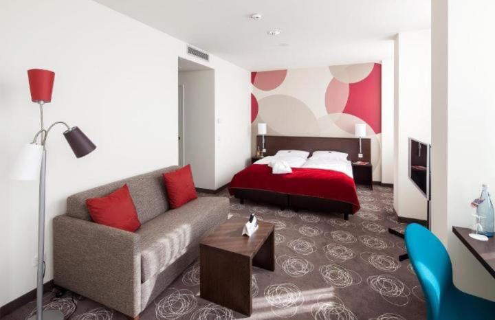 a living room with a couch and a bed at Sebail Inn Hotel Badamdar and Shah Hostel in Baku
