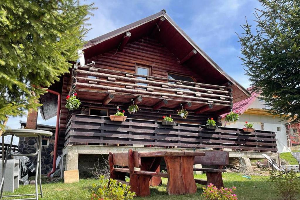 a house with potted plants on the front of it at 3 Bed Chalet Sleeps 8 -Fireplace & Enclosed Garden in Sohodol