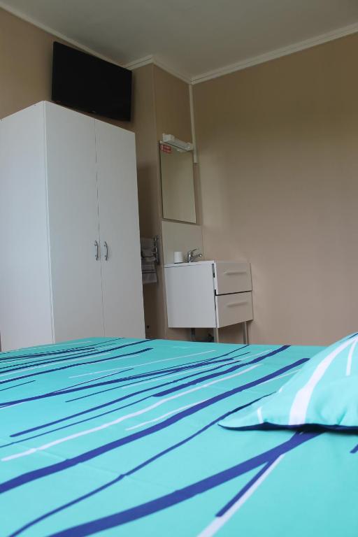Postel nebo postele na pokoji v ubytování Le Bellevue Lisieux