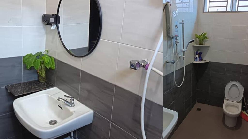 een badkamer met een wastafel en een spiegel en een douche bij Melody Homestay in Kuala Kedah