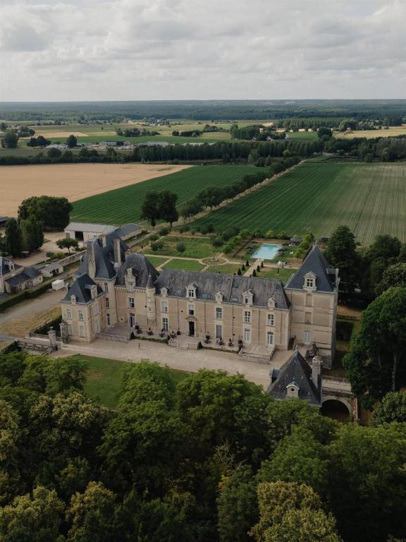 an aerial view of a large house on a hill at Chateau De Jalesnes in Vernantes