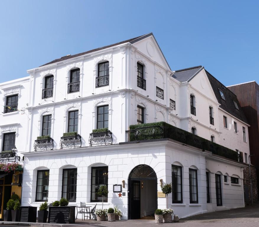 a white building with black doors and windows at Killarney Royal Townhouse in Killarney