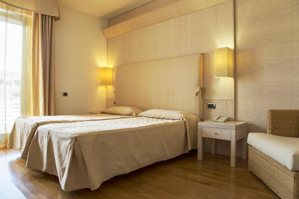 Łóżko lub łóżka w pokoju w obiekcie Hotel Mara