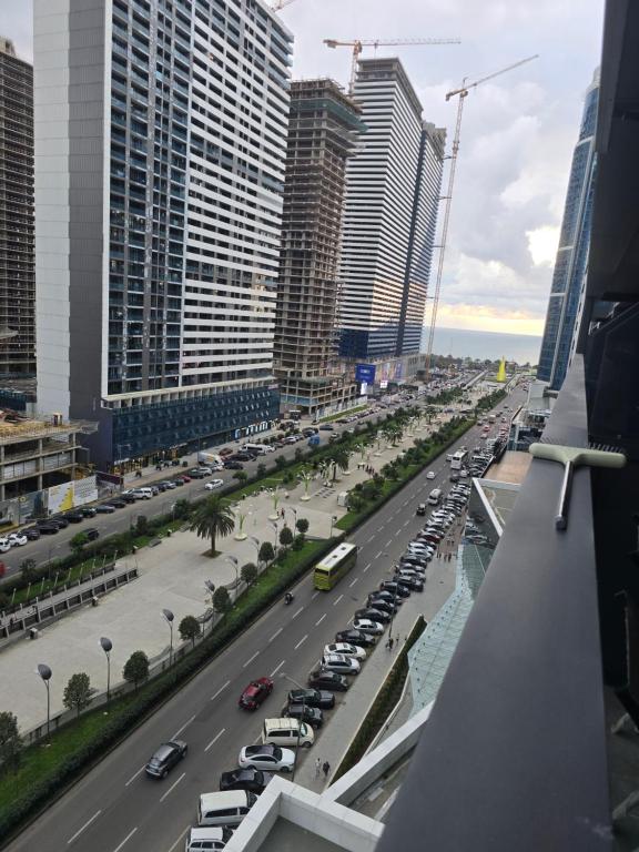 una calle de la ciudad con coches aparcados en un estacionamiento en Blue sky, en Itʼkhvisi