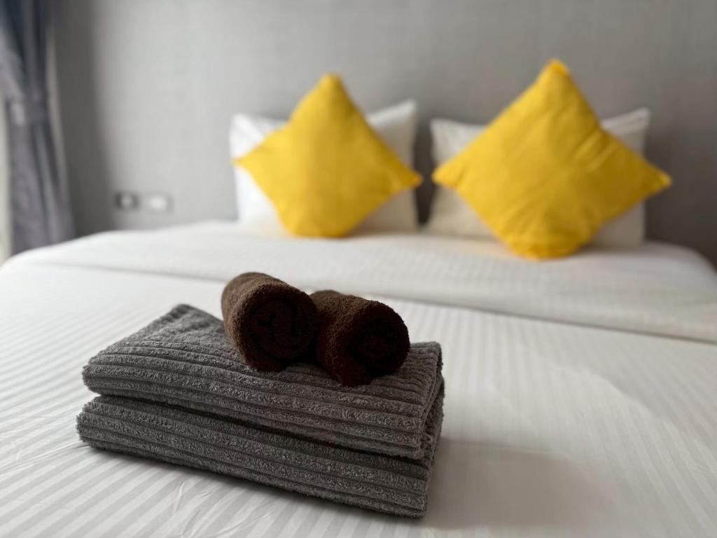 a pile of towels sitting on top of a bed at Emerald Terrace Resort 622 in Patong Beach