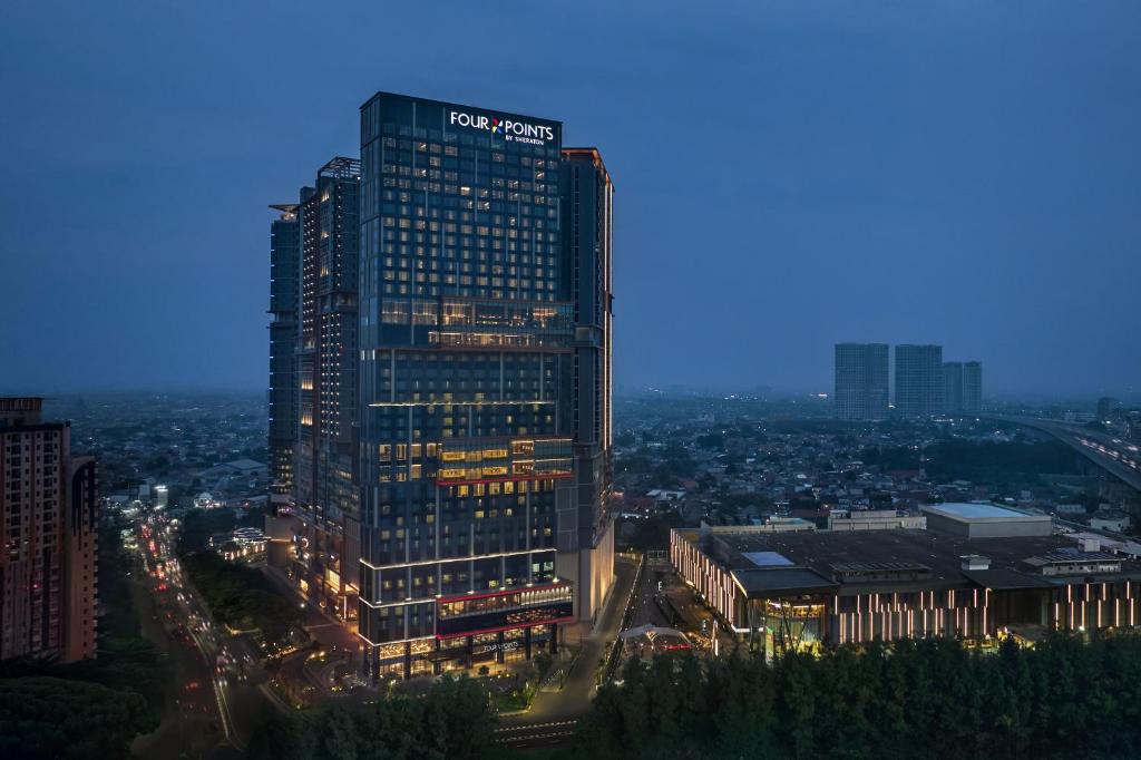 a tall building with a pepsi sign on top of it at Four Points by Sheraton Bekasi in Bekasi
