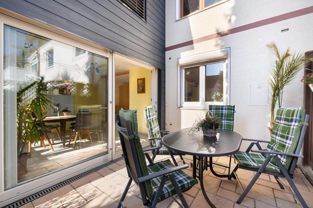a patio with a table and chairs at Cathleen Bohnert in Lindau