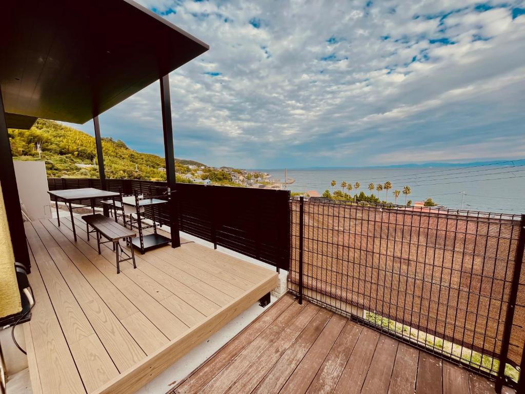 a wooden deck with a table and chairs on it at AWAJI OCEAN BASE east coast in Awaji