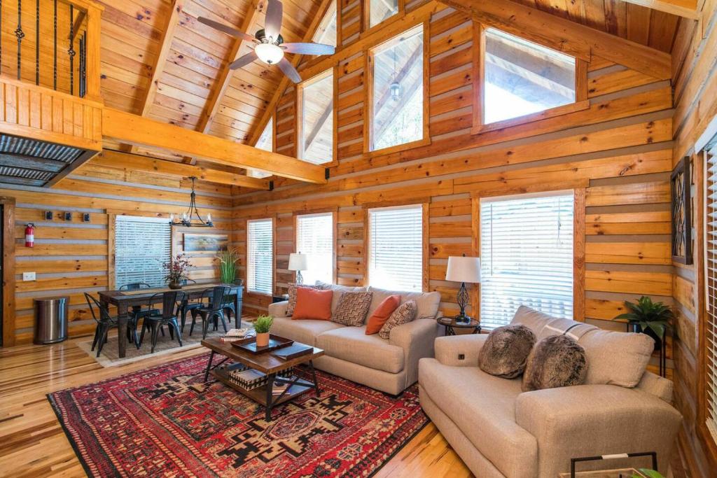 a living room with couches and a table in a cabin at Hot Tub & WiFi - Big Boulder - Red River Gorge KY in Rogers