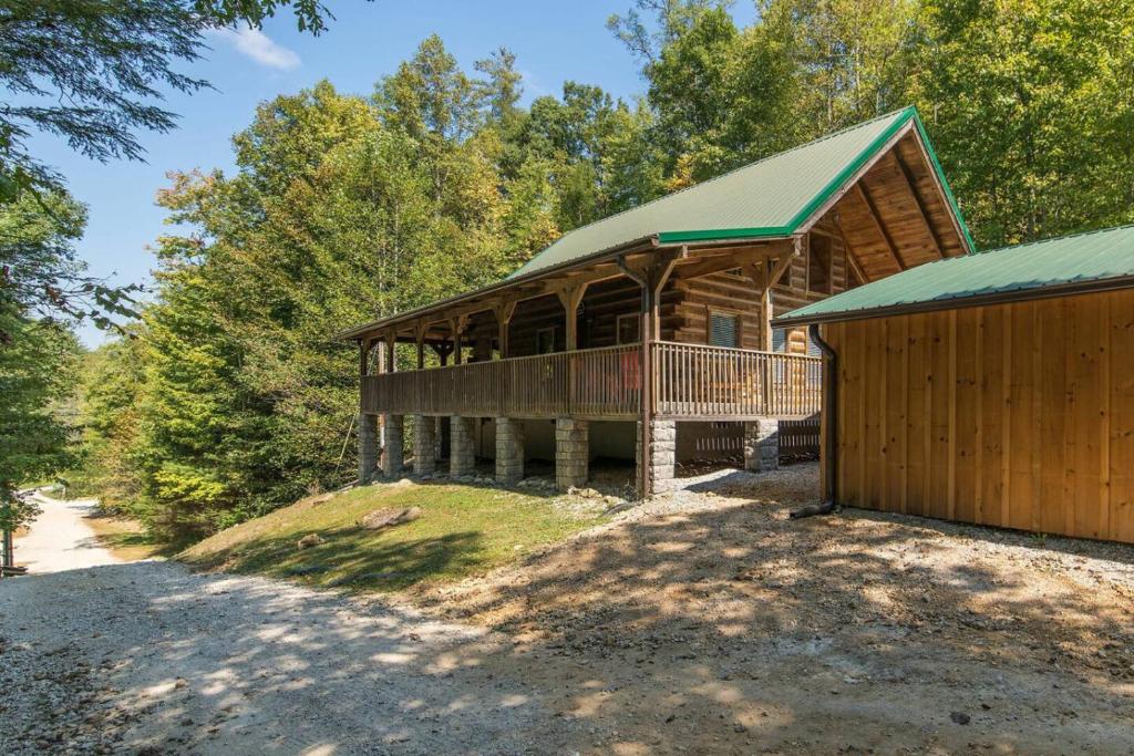 a large log cabin with a porch and a garage at Hot Tub & WiFi - Big Boulder - Red River Gorge KY in Rogers