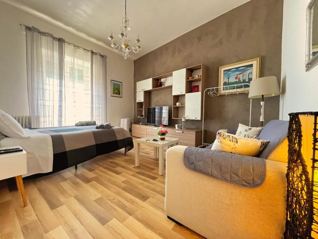 a bedroom with a bed and a couch in a room at Mediterraneo Travel in Gela