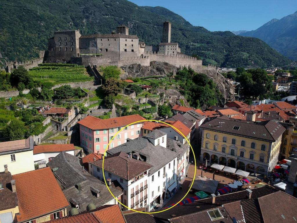 an aerial view of a town with a castle at Wonderful apartment in the historic center in Bellinzona