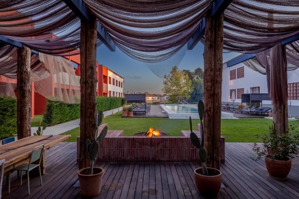 a gazebo with a fire pit on a patio at Hotel da Barrosinha in Alcácer do Sal
